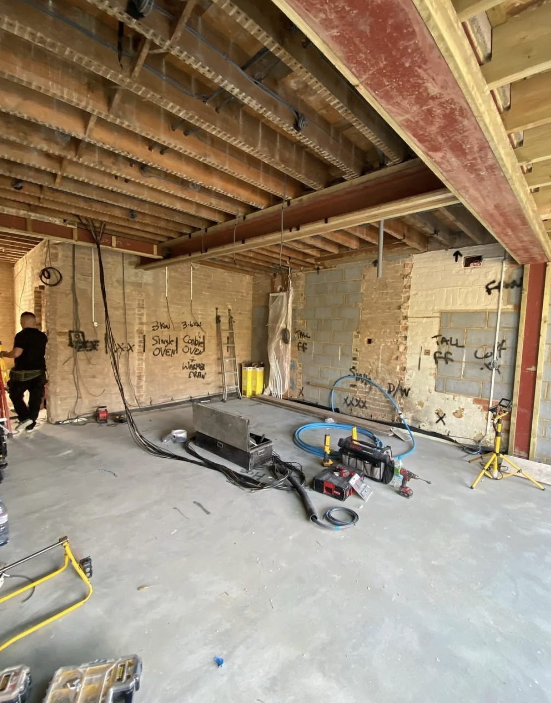 First fix wiring through floor joists with circuits marked on brickwork